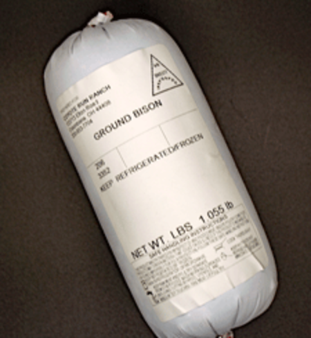 Ground bison packaged in a vacuum-sealed bag, labeled with weight and storage instructions, displayed against a dark background.