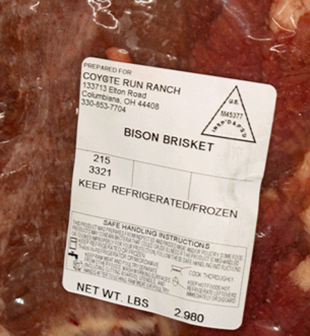 Label of bison brisket from Coyote Run Ranch, showing preparation details, storage instructions, and weight of 2.980 lbs.