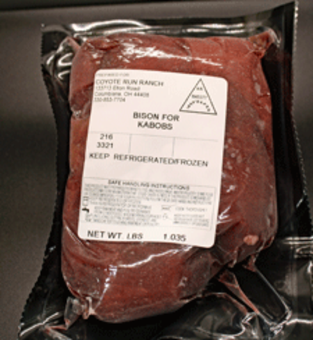 Bison meat packaged for kabobs, featuring a clear label with handling instructions and nutritional information. The product weighs 1.85 pounds and is from Coyote Run Ranch.